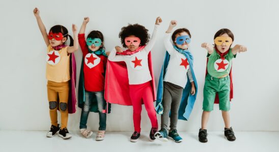 Group of Diverse Children Playing superhero on the white wall background. Superhero concept.